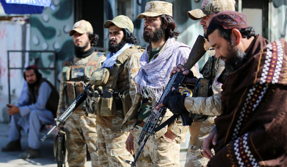 Taliban security personnel stand guard along a road near the Torkham border crossing in Nangarhar province, Afghanistan, on Feb. 20, 2023. (AFP)