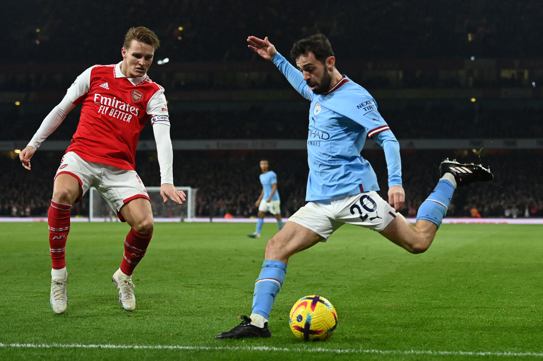 Manchester City's Portuguese midfielder Bernardo Silva (R) shoots the ball during the English Premier League football match between Arsenal and Manchester City at the Emirates Stadium in London. (File/AFP)