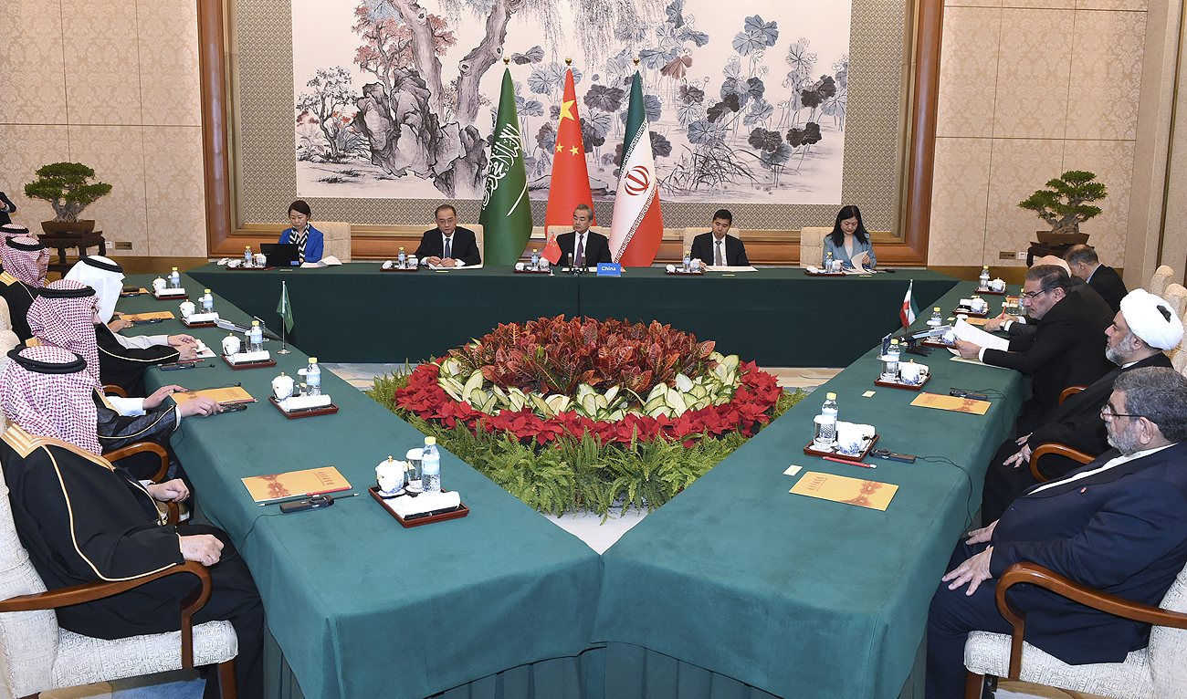 In this photo released by Xinhua News Agency, Wang Yi, China's most senior diplomat (center) presides over a closed meeting between Iran, led by Ali Shamkhani, the secretary of Iran's Supreme National Security Council (right) and Saudi Arabia, led by Saudi national security adviser Musaad bin Mohammed al-Aiban (left) in Beijing, Saturday, March 11, 2023. (Photo courtesy: AP)