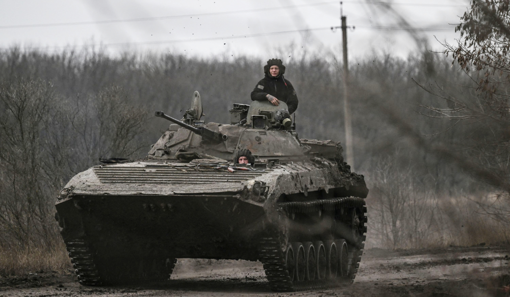 Ukrainian servicemen on a BMP-2 tank drive towards the city of Bakhmut on March 11, 2023 amid the Russian invasion of Ukraine. (AFP)