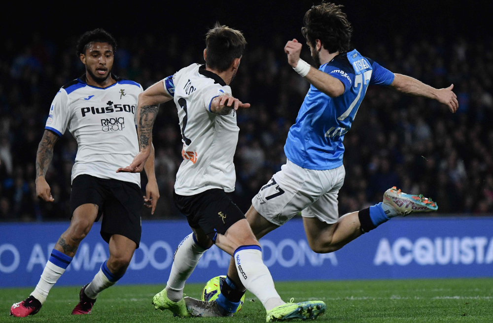 Napoli's Georgian forward Khvicha Kvaratskhelia (R) shoots to open the scoring during the Italian Serie A football match between Napoli and Atalanta on Saturday at the Diego-Maradona stadium in Naples. (AFP)