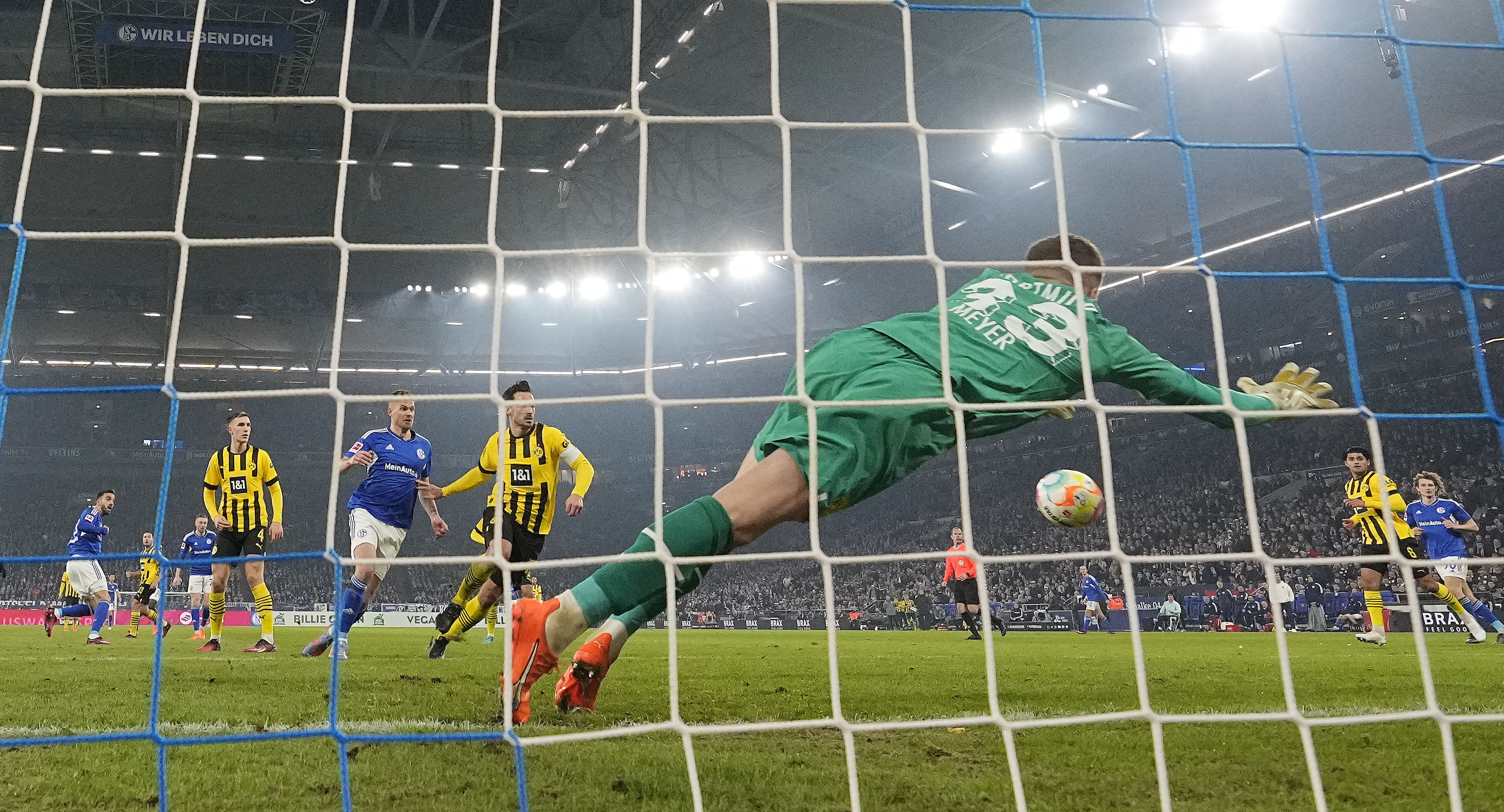 Schalke's Kenan Karaman, left, scores his side's second goal past Dortmund's goalkeeper Alexander Meyer, right, during their German Bundesliga soccer match in Gelsenkirchen, Germany, Saturday. (AP)