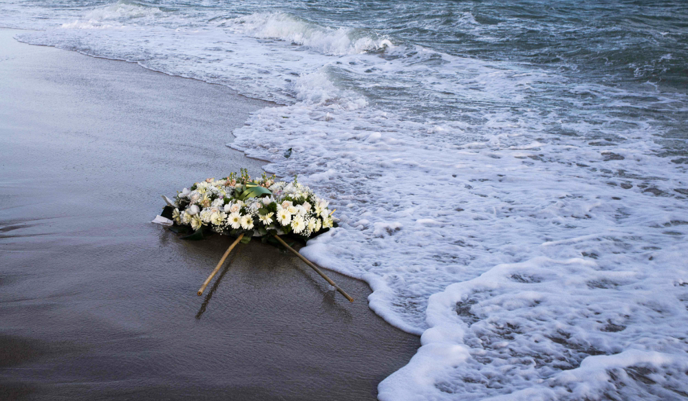 A wreath of flowers floats on the Mediterranean Sea, thrown by people who ended a protest march on the beach at the site of the shipwreck on March 11, 2023 in Steccato di Cutro, Calabria region. (AFP)