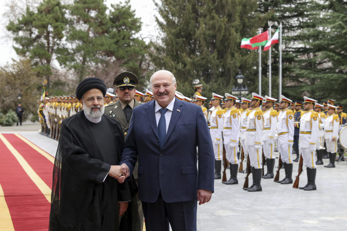 President Ebrahim Raisi, left, shakes hands with Belarusian President Alexander Lukashenko in an official welcoming ceremony at the Saadabad Palace in Tehran. (Iranian Presidency Office via AP)