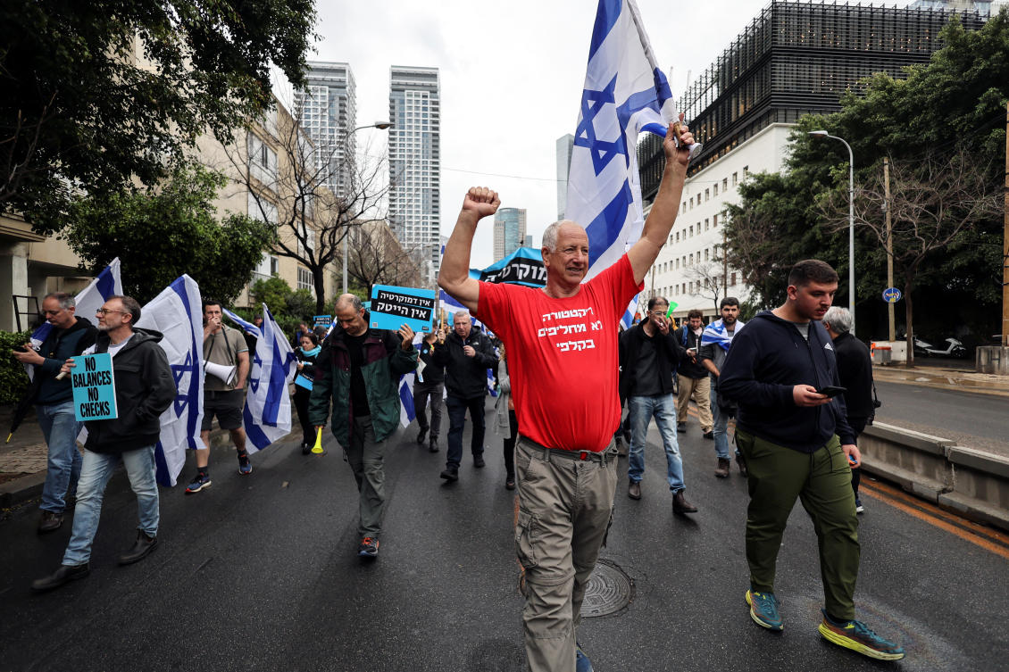 An Israeli protester wears a t-shirt that reads “You don’t switch a democracy at the ballot” during a demonstration in Tel Aviv on March 14, 2023. (Reuters)