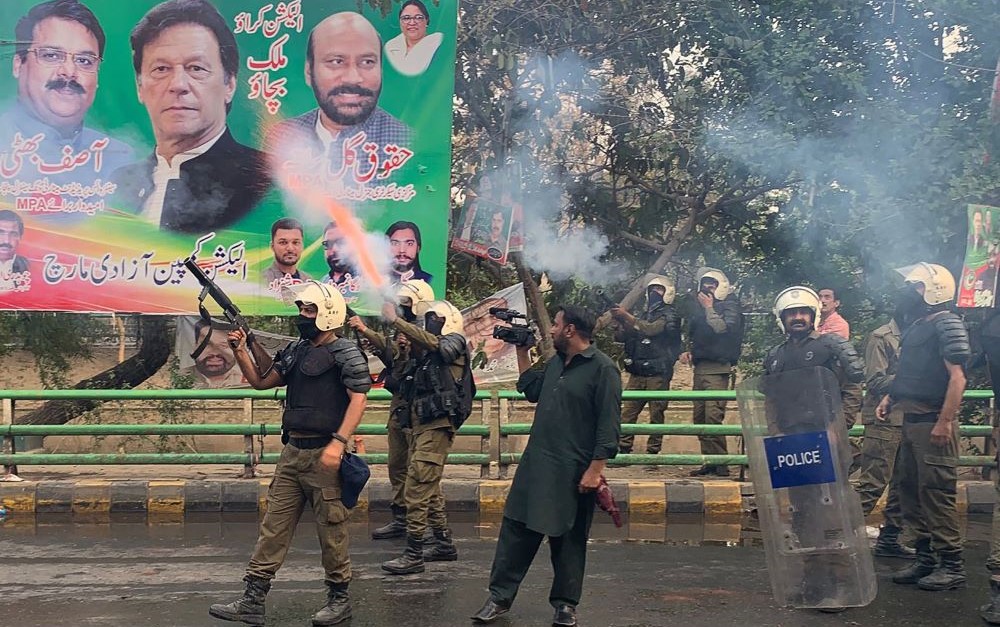 Riot police fire teargas shells to push back supporters of former PM Imran Khan, who were gathered outside Khan’s house to prevent officers from arresting him, Lahore, Pakistan, Mar. 14, 2023. (AFP)