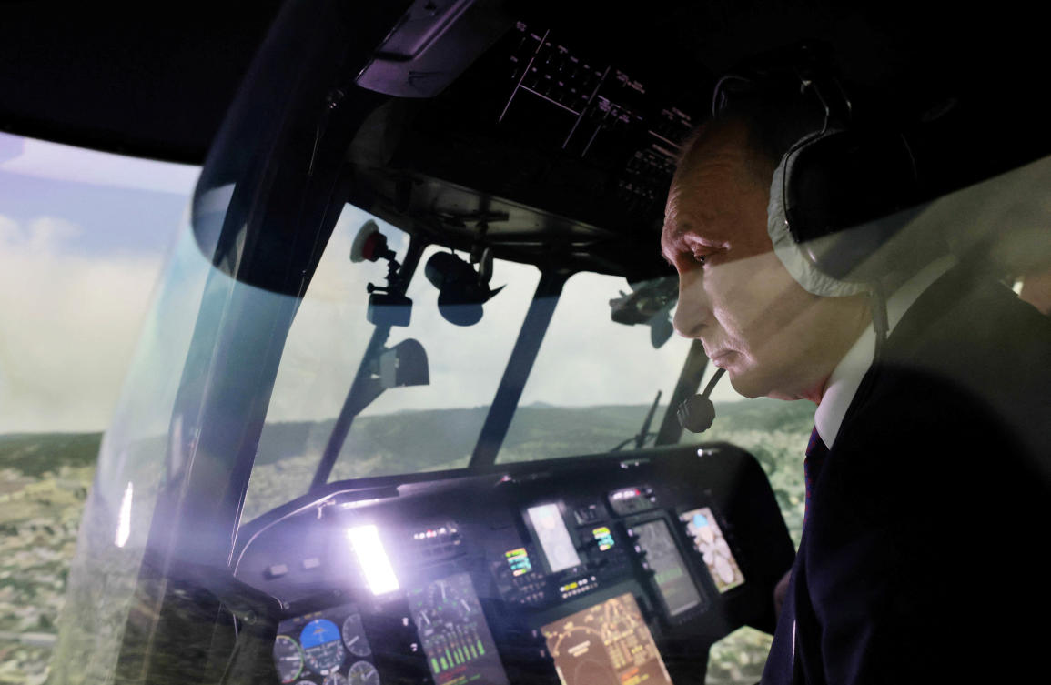 Russian President Vladimir Putin in the cockpit of a helicopter simulator at an aviation plant in Ulan-Ude, Buryatia, Russia, Mar. 14, 2023. (Reuters)