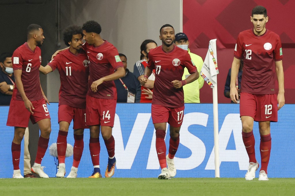 Qatar's forward Almoez Ali (3rd-L) with his team during the FIFA Arab Cup 2021 quarter final football match between Qatar and the United Arab Emirates at the Al-Bayt Stadium in the Qatari city of Al-Khor on December 10, 2021.(AFP)
