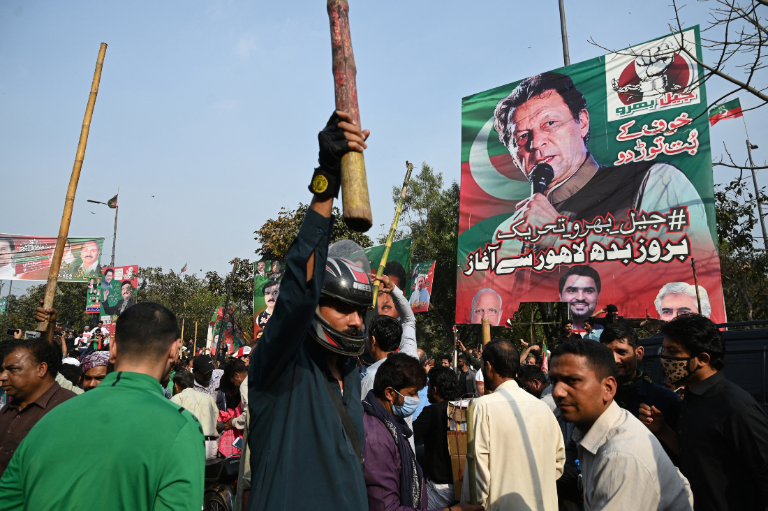 Supporters of former Pakistan's prime minister Imran Khan block a road near Khan's residence to prevent officers from arresting him in Lahore. (AFP)