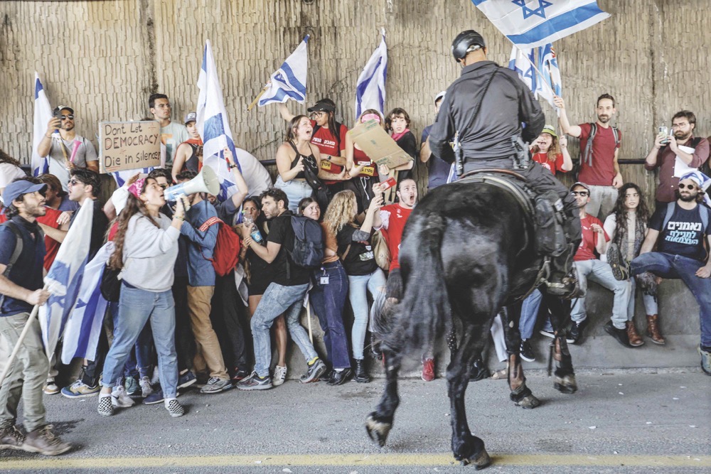 Israeli mounted police confront demonstrators in Tel Aviv on Thursday during a protest against the government’s controversial judicial reform bill. (AFP)