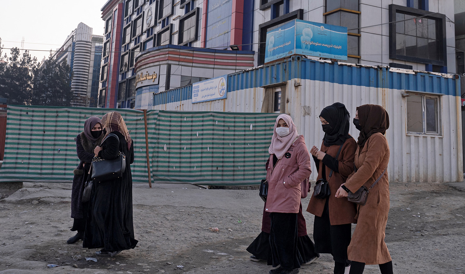 Afghan female university students walk on their on way back home past a private university in Kabul on December 21, 2022. (AFP/File)