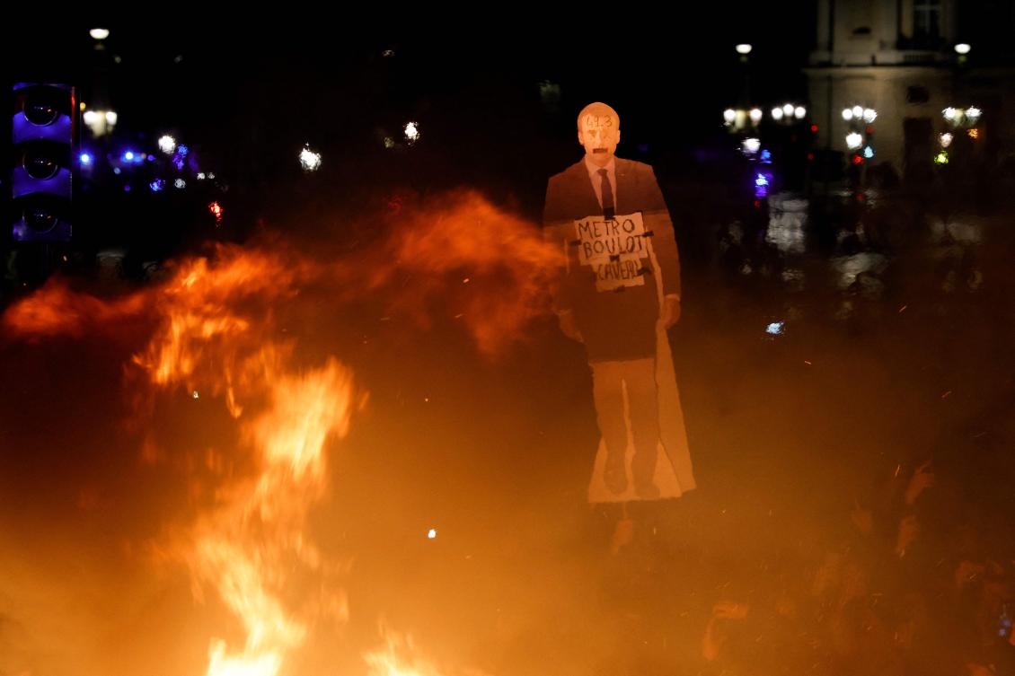 An effigy of French President Emmanuel Macron is held up near a fire during a demonstration in Paris on Mar. 17, 2023, the day after the French government pushed a pensions reform using the article 49.3 of the constitution. (AFP)