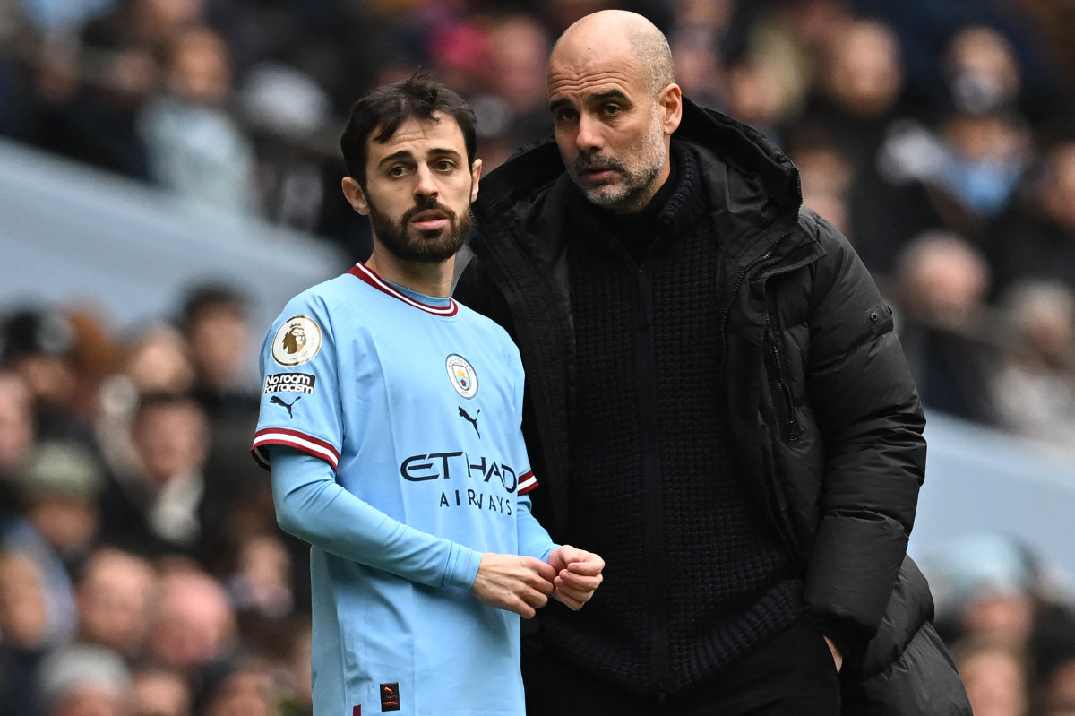 Manchester City's manager Pep Guardiola (R) speaks with midfielder Bernardo Silva (L) before bringing him on as a substitute during an English Premier League football match on March 4, 2023. (AFP file)