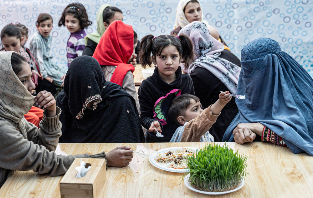 Afghan customers wait for their food to be served at a restaurant named ‘Banowan-e- Afghan’ that employs female staff in Kabul on March 16, 2023. (AFP)