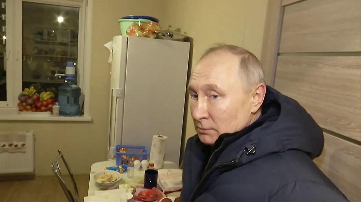 This handout video grab shows Russian President Vladimir Putin visiting a flat at a newly built neighborhood during his visit to Mariupol in Russian-controlled Donetsk region. (AFP)