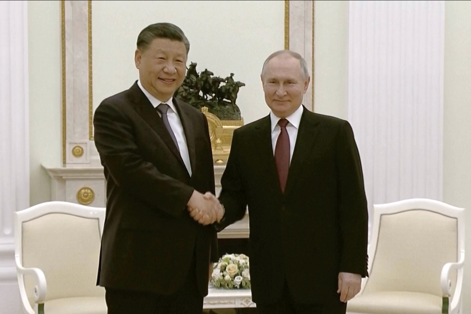 China's President Xi Jinping, left, and Russian President Vladimir Putin shake hands during their meeting in Moscow, March 20, 2023. (AP)