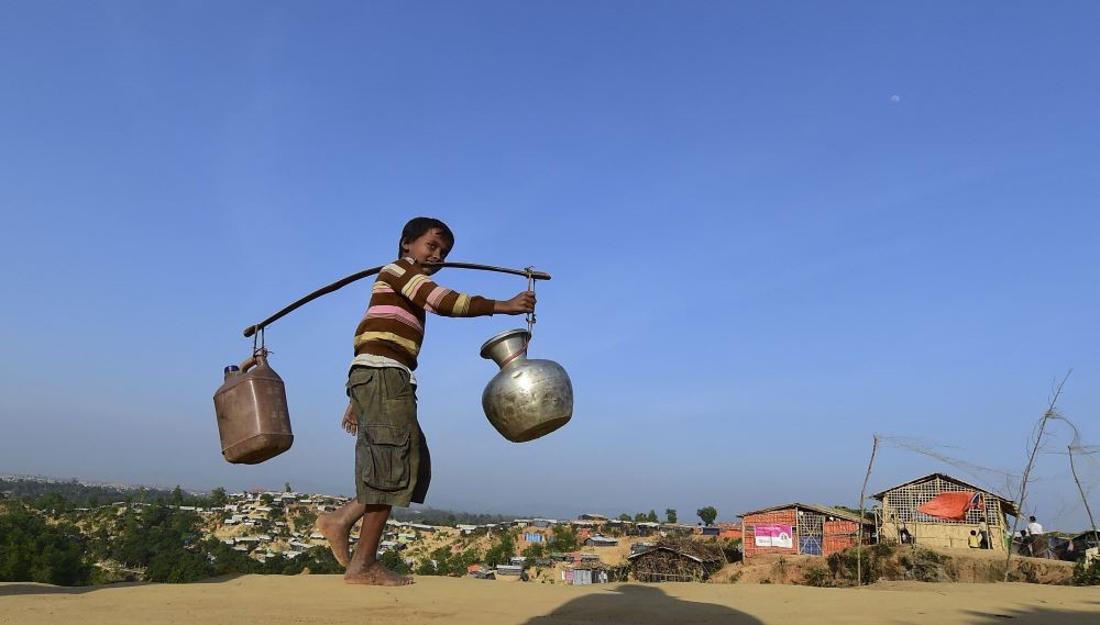 A Rohingya refugee child walks back to his makeshift shelter after collecting water at Hakimpara refugee camp in Bangladesh’s Ukhia district on January 27, 2018. (AFP)