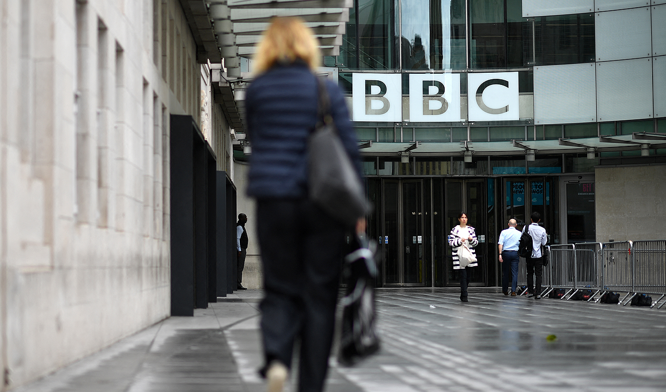 In this file photo taken on July 2, 2020, people walk outside the BBC headquarters in Portland Place, London. (Photo courtesy: AFP/File)