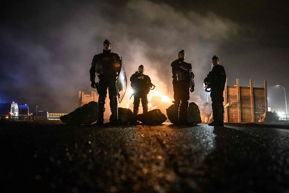 French gendarmes secure an area on March 21, 2023 in Donges, western France after protests broke out across the country. (AFP)