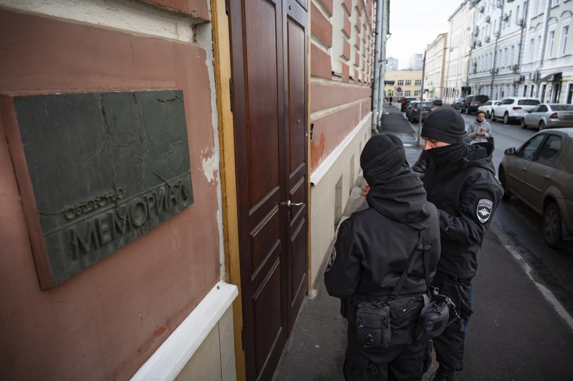 Two Russian police officers stand in front the door of the Memorial office in Moscow, Russia, Mar. 21, 2023. (AP)
