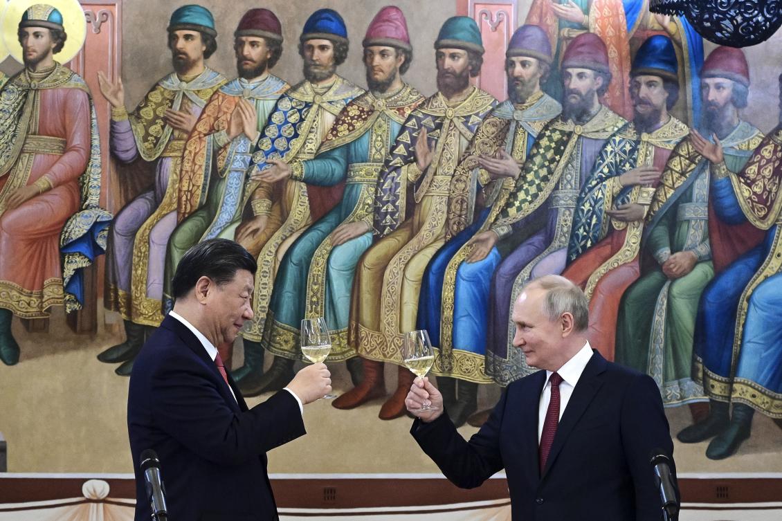 Russian President Vladimir Putin and Chinese President Xi Jinping toast during their dinner in the Palace of the Facets, in the Kremlin, Moscow, Russia, Tuesday, March 21, 2023. (AP Photo)