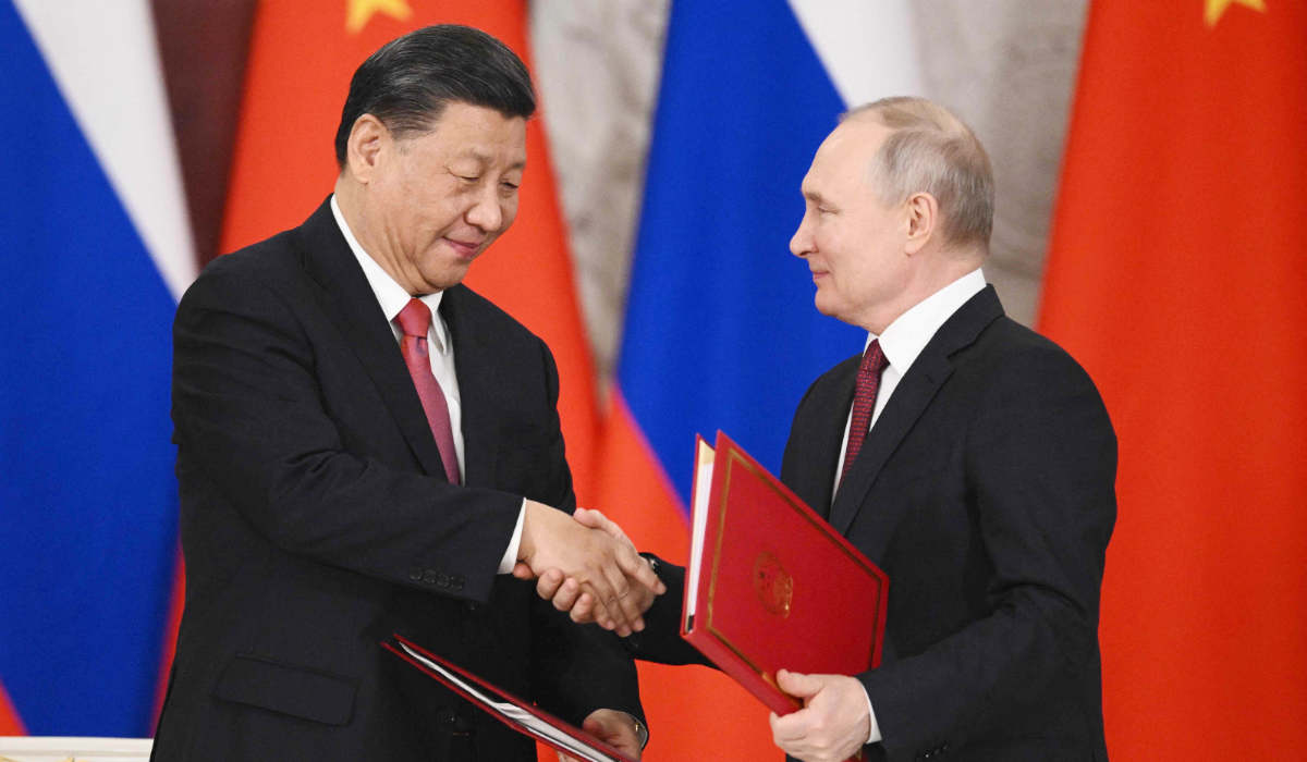 Russian President Vladimir Putin and China's President Xi Jinping shake hands during a signing ceremony following their talks at the Kremlin in Moscow on March 21, 2023. (AFP)