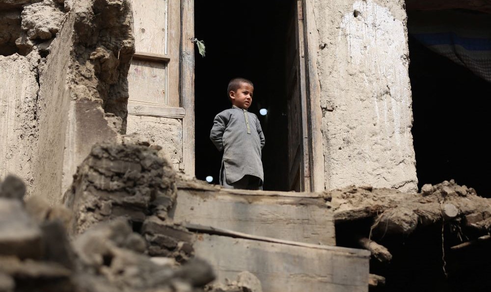 A boy looks out from his damaged home in Miya village, in the Alishing District of Laghman Province, Afghanistan, on March 22, 2023, following an overnight earthquake. (AFP)