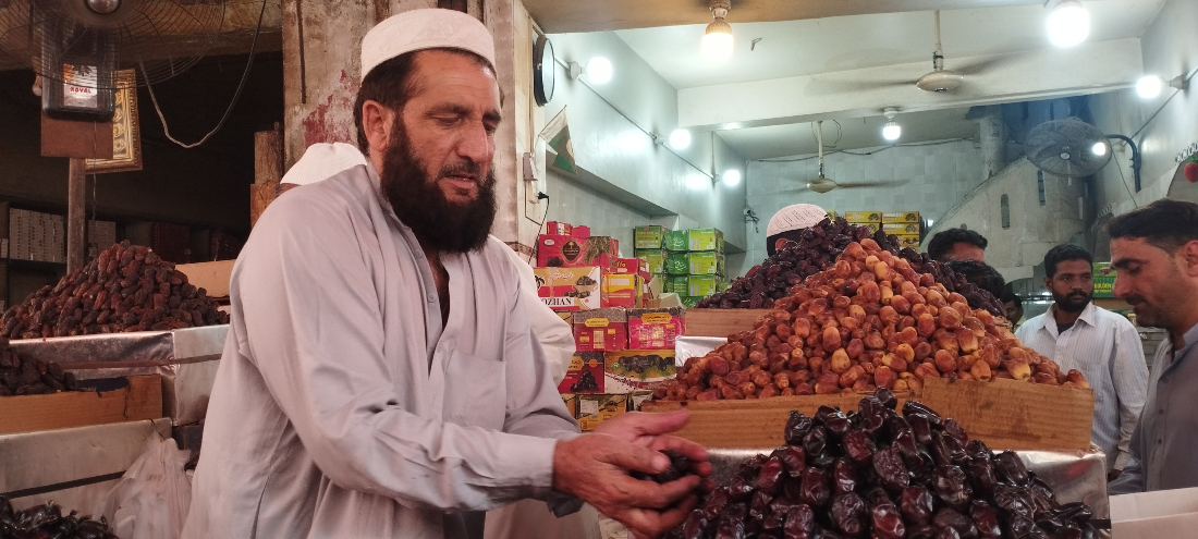 A dates seller in his stall at Pakistan's biggest date market in Karachi. (AN Photo)