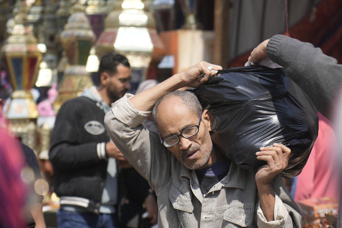 A man carries his shopping food ahead of the upcoming Muslim fasting month of Ramadan, in Cairo, Egypt. (File/AP)