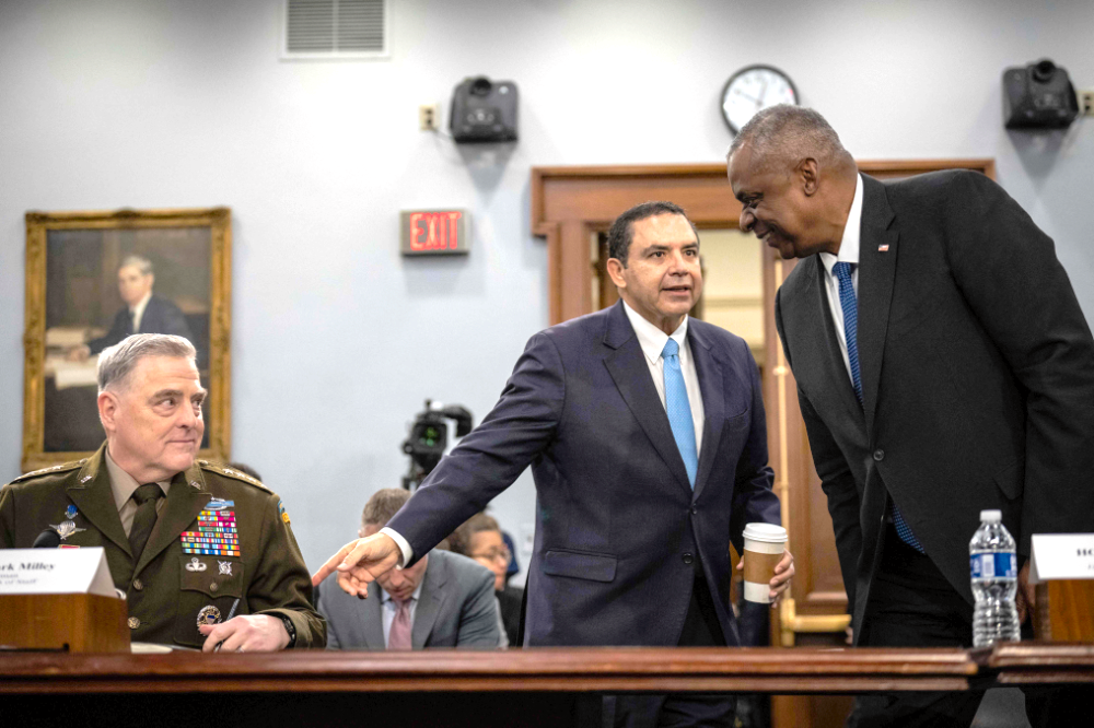 Chairman of the Joint Chiefs of Staff General Mark Milley and U.S. Secretary of Defense Lloyd Austin are greeted by Rep. Henry Cuellar (D-TX) before the start of a House Appropriations Defense Subcommittee hearing on Capitol Hill March 23, 2023 in Washington, DC. (Getty Images/AFP)