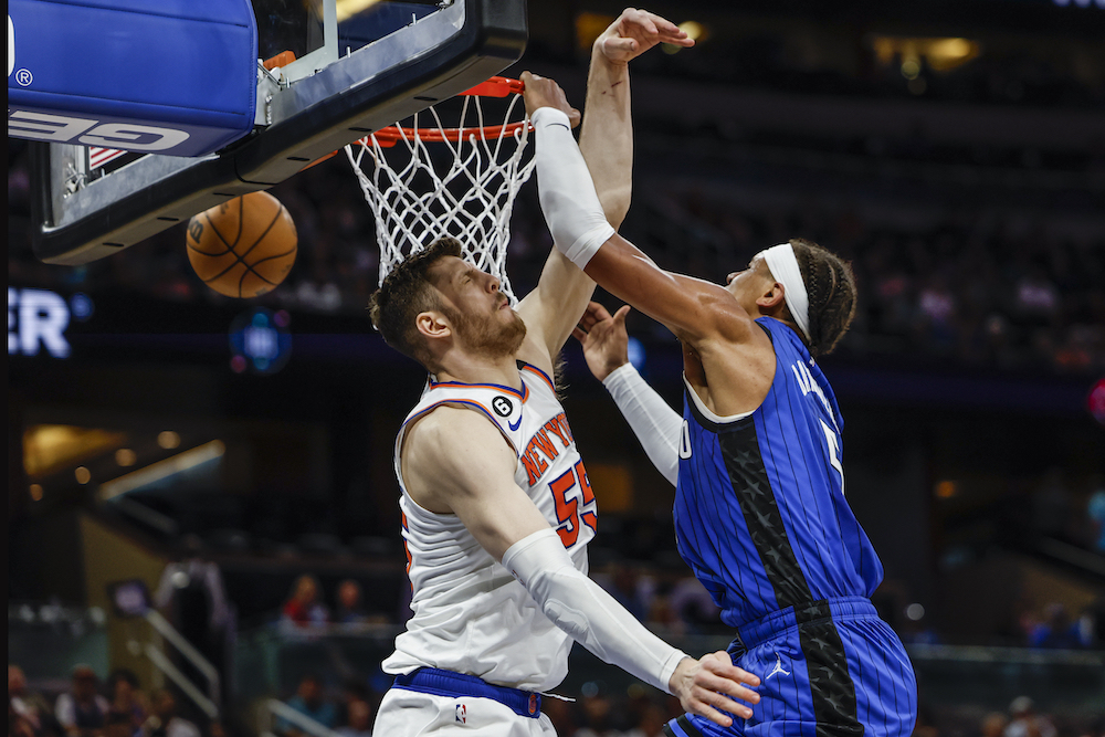 Orlando Magic forward Paolo Banchero, right, dunks over New York Knicks center Isaiah Hartenstein during the second half of an NBA basketball game Thursday in Orlando, Florida. (AP)