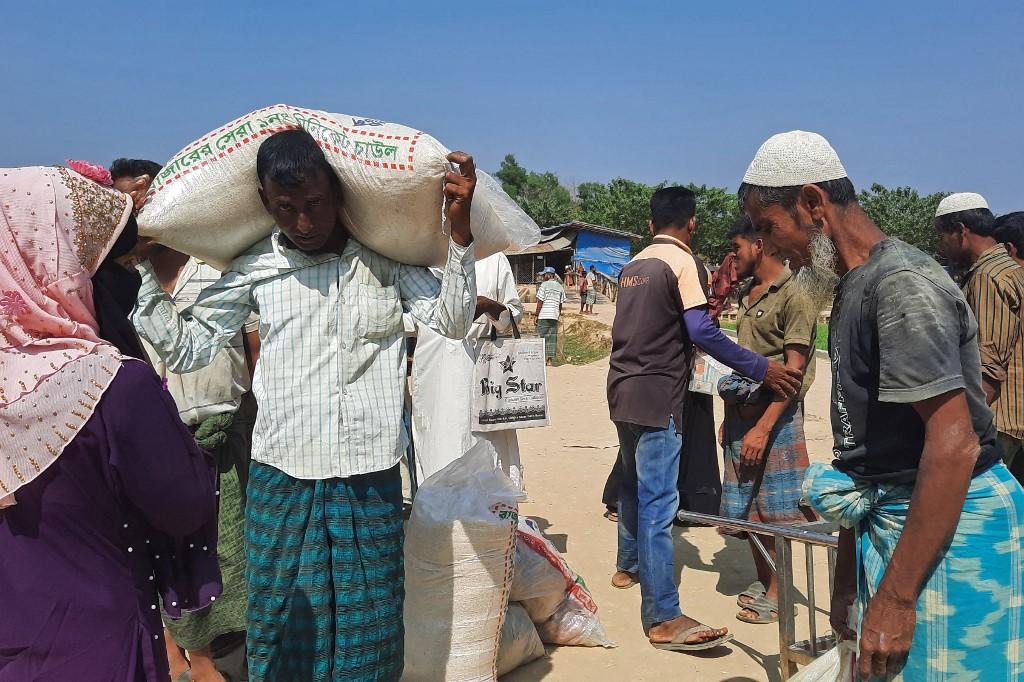 A military crackdown in Myanmar in 2017 sent hundreds of thousands of Rohingya fleeing into neighboring Bangladesh with harrowing stories of murder, rape and arson. Above, Rohingyas collect relief materials at Kutupalong refugee camp in Bangladesh. (AFP)