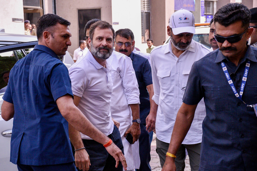 India's Congress party leader Rahul Gandhi, second left, arrives at the district court in Surat on March 23, 2023. (AFP)