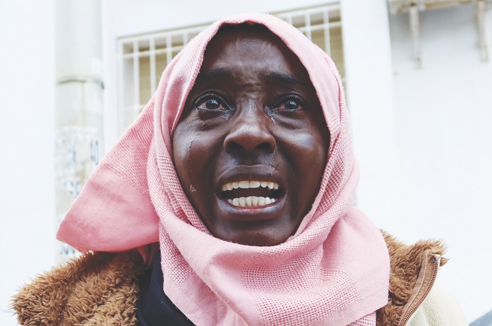 Sudanese refugee Awadhya Hasan Amine reacts during a protest asking for evacuation outside the headquarters of UN High Commissioner for Refugees in Tunis. (Reuters)