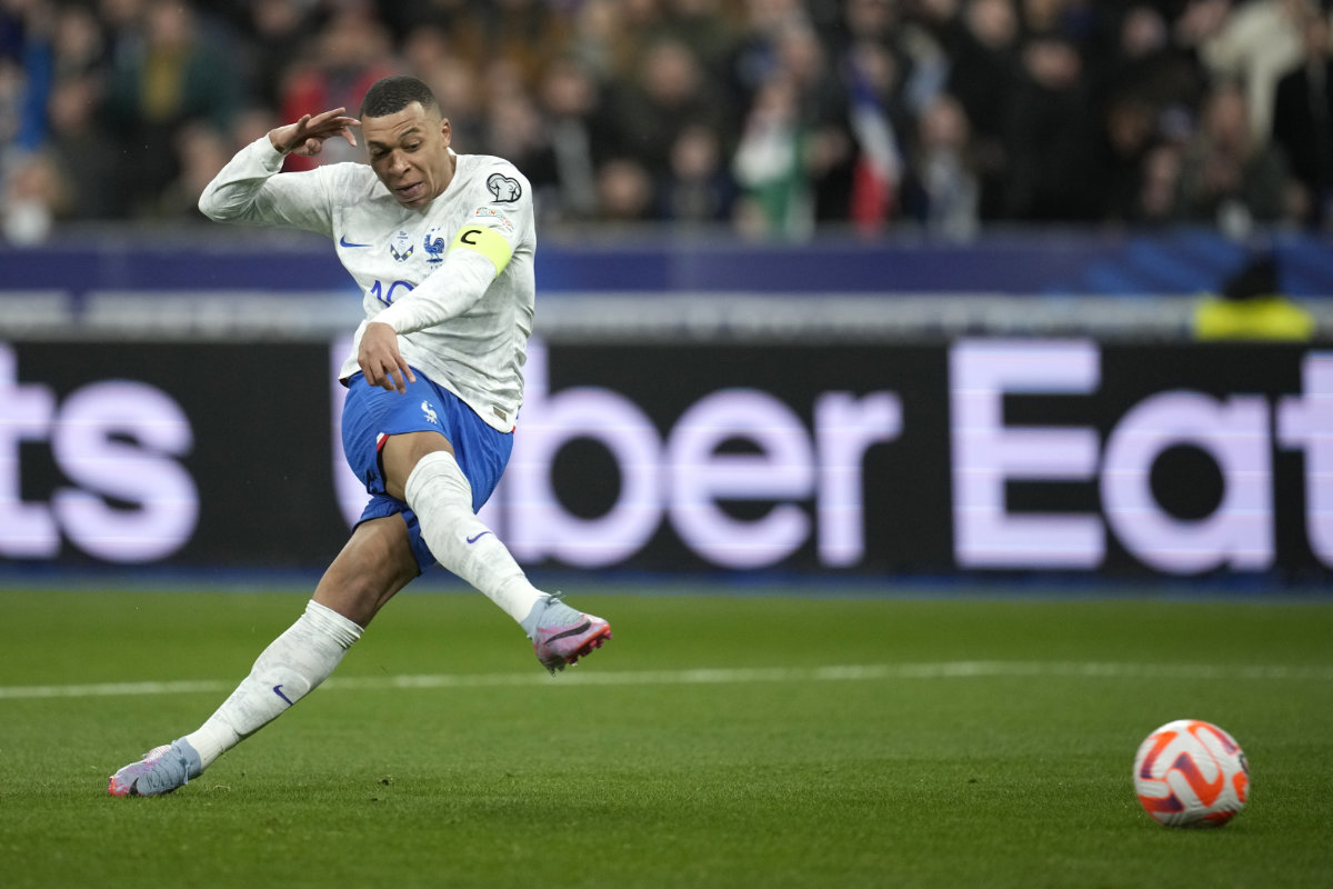 France's Kylian Mbappe scores his side's third goal during the Euro 2024 Group B qualifying soccer match between France and the Netherlands at the Stade de France in Saint Denis, outside Paris, on March 24, 2023. (AP)