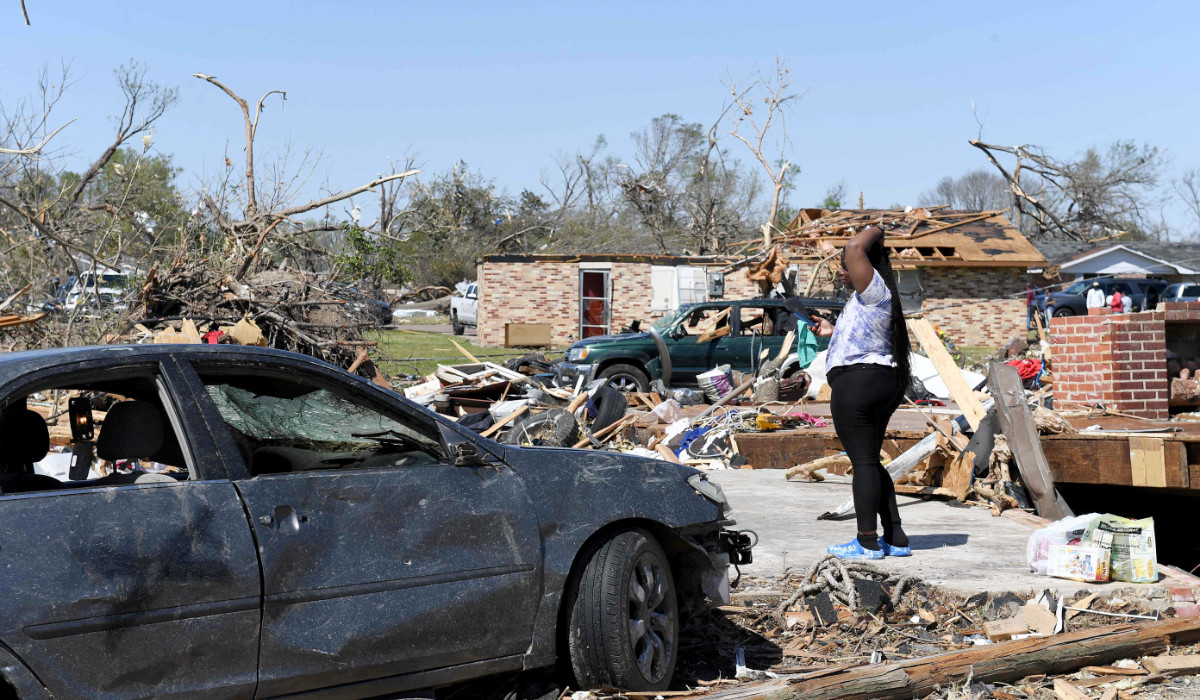 Kenterica Sardin, 23, stands where her bedroom once was after being damaged from a series of powerful storms and at least one tornado on March 25, 2023 in Rolling Fork, Mississippi. (AFP)