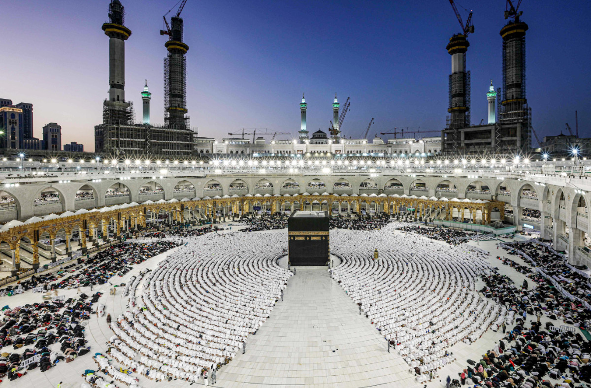 Muslim worshippers gather before the Kaaba, Islam's holiest shrine, as they perform the Maghrib (sunset) prayer to mark the end of the first day of fasting in the holy month of Ramadan, at the Grand Mosque in the holy city of Makkah on March 23, 2023. (AFP)