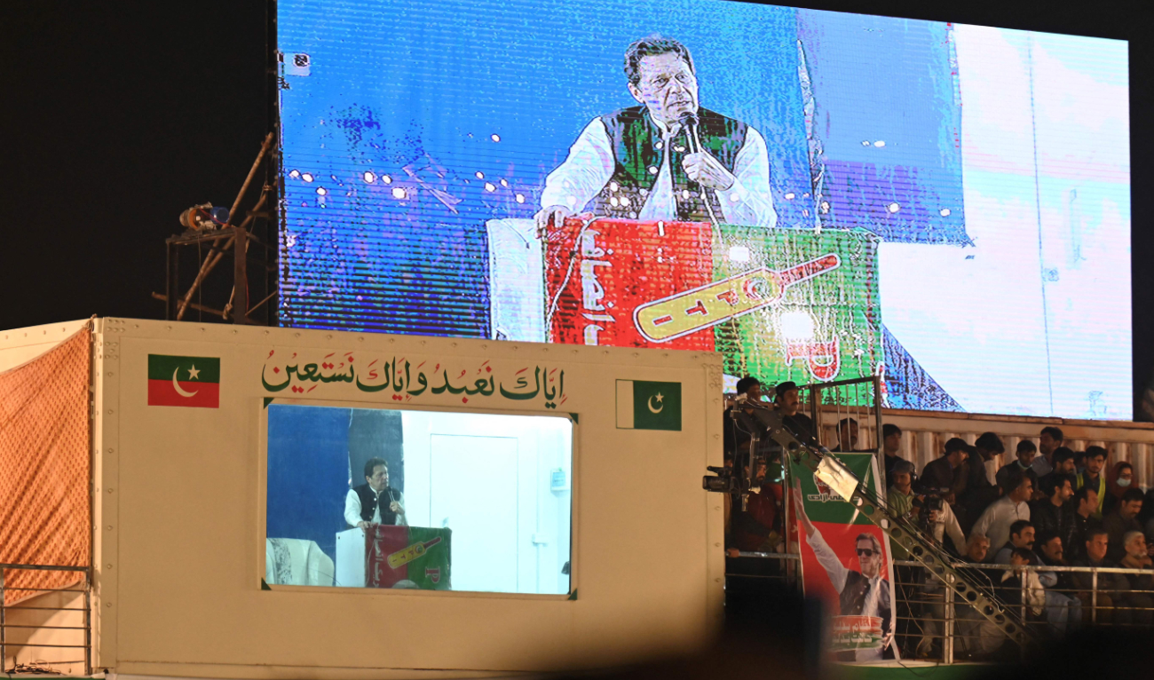 Pakistan’s former Prime Minister Imran Khan speaks to his supporters from behind a bulletproof shield at a rally in Lahore on Saturday. (AFP)