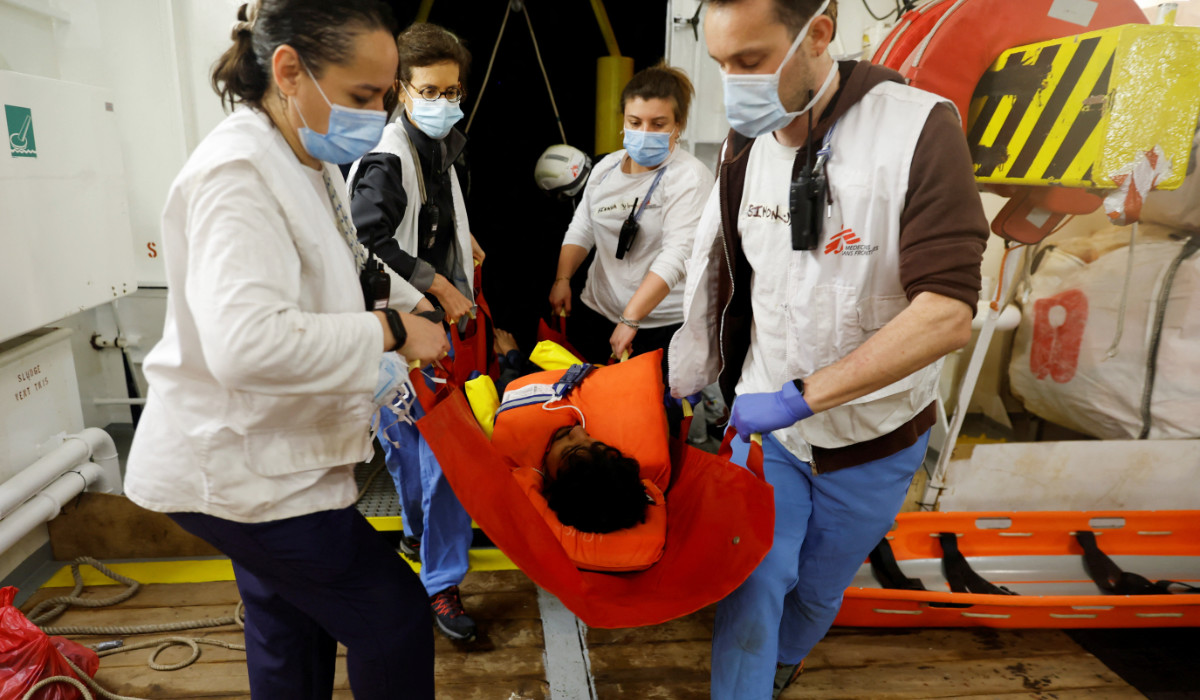 Medics carry a semi-conscious migrant on the Geo Barents rescue ship, operated by Medecins Sans Frontieres (Doctors Without Borders), after being rescued from a wooden boat off the coast of Libya in the central Mediterranean Sea March 24, 2023. (REUTERS)