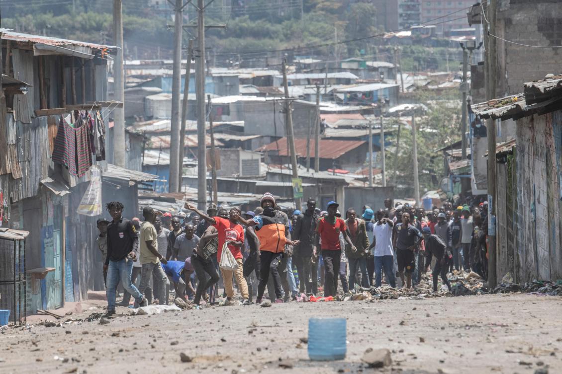 Protesters hurl stones at anti-riot police during a standoff at a mass rally called by the opposition leader Raila Odinga, on March 27, 2023. (AFP)