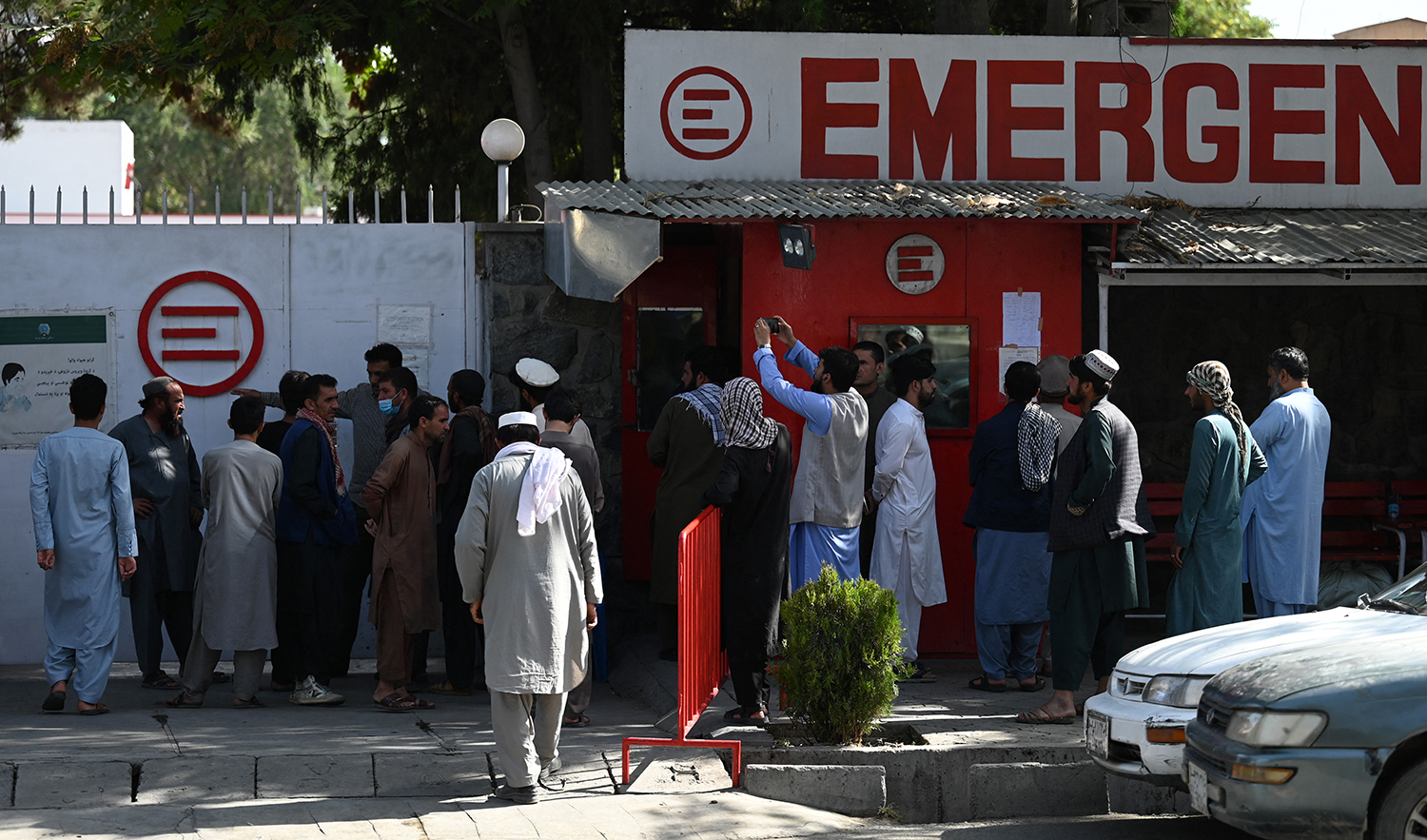 People gather to check on missing relatives a day after a twin suicide bombs attack, which killed scores of people outside Kabul airport, at a hospital run by Italian NGO Emergency in Kabul, Afghanistan, on August 27, 2021. (AFP/File)