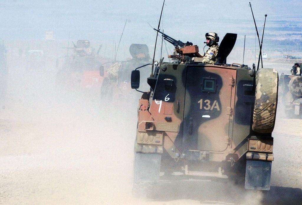 Above, Australian soldiers patrol in Tirin Kot of Afghanistan’s Uruzgan province on Feb. 17, 2007. Up to 19 current and former Australian special forces soldiers face charges for illegal conduct in Afghanistan, including war crimes. (AFP file photo)