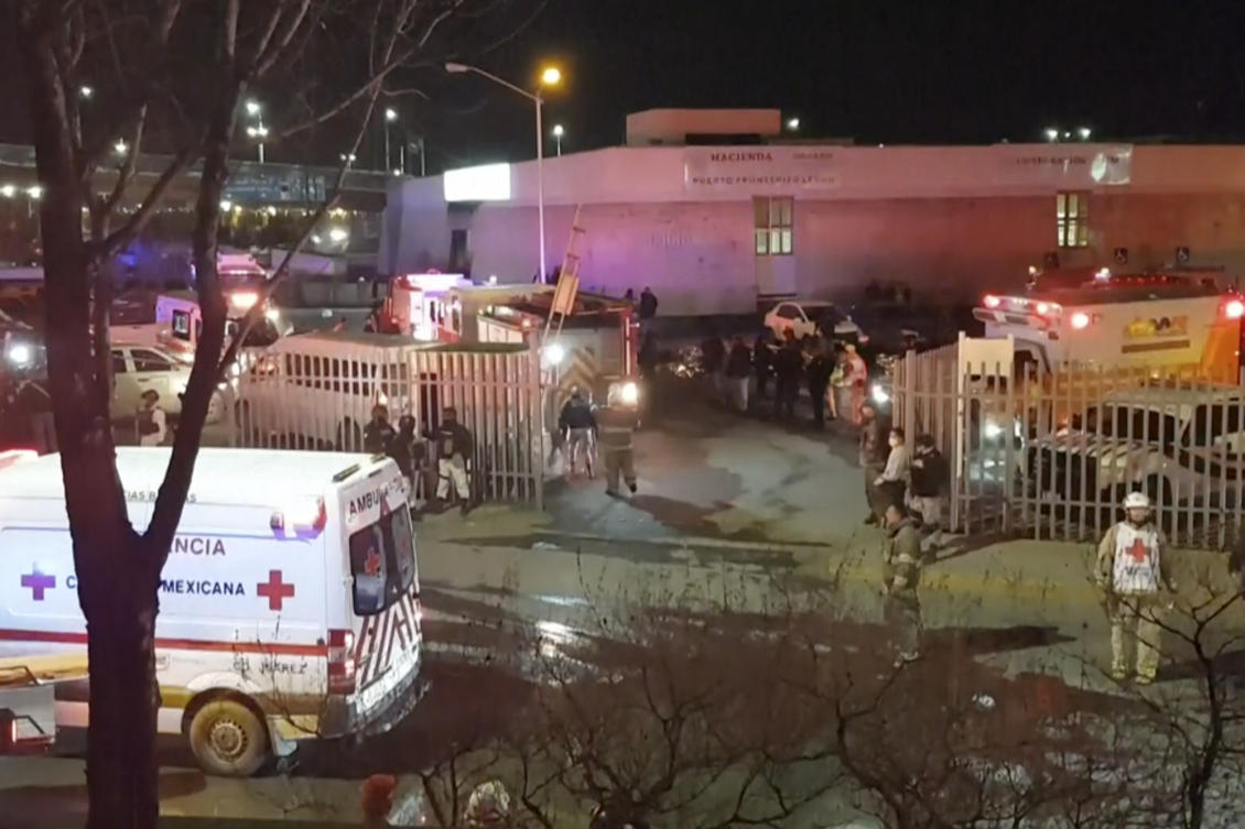 Image taken from a video showing ambulances and rescue teams staffers outside an immigration center in Ciudad Juarez, Mexico, Tuesday, March 28, 2023. (AP Photo)