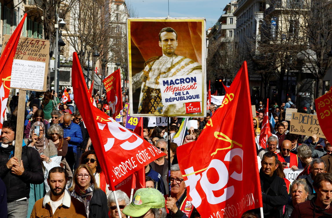Protesters hold a placard depicting French President Emmanuel Macron as a king during a demonstration as part of the tenth day of nationwide strikes and protests against French government’s pension reform in Nice, on Mar. 28, 2023. (Reuters)