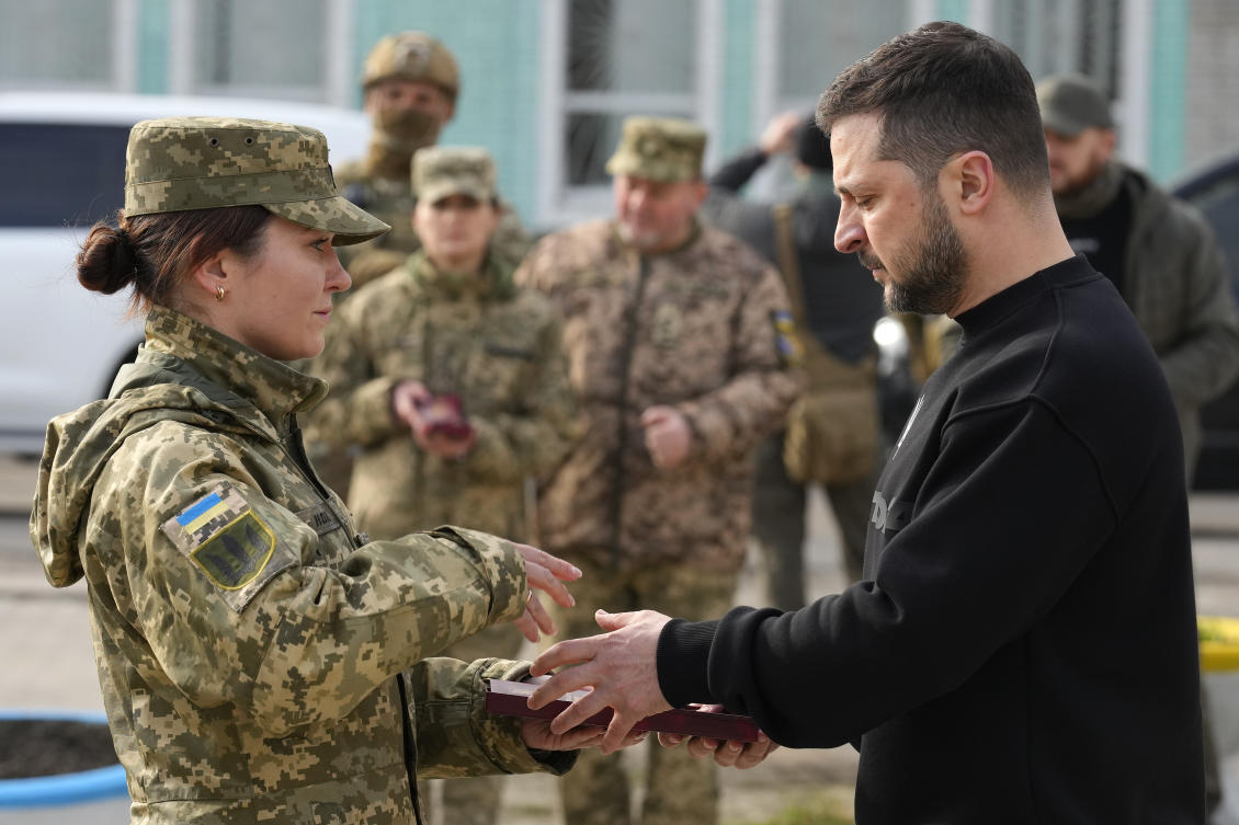 Ukrainian President Volodymyr Zelensky presents a medal to a servicewoman in Okhtyrka in the Sumy region of Ukraine on Mar. 28, 2023. (AP)
