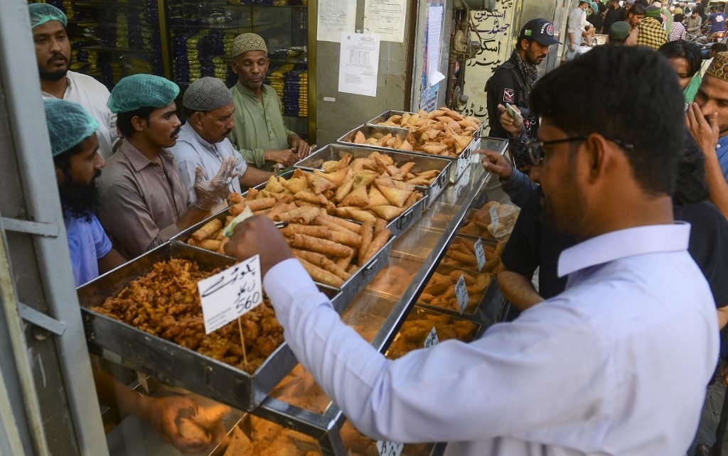 Pakistanis buy iftar food at a market before breaking their fast on the first day of the holy month of Ramadan, Karachi, March 23, 2023. (AFP)