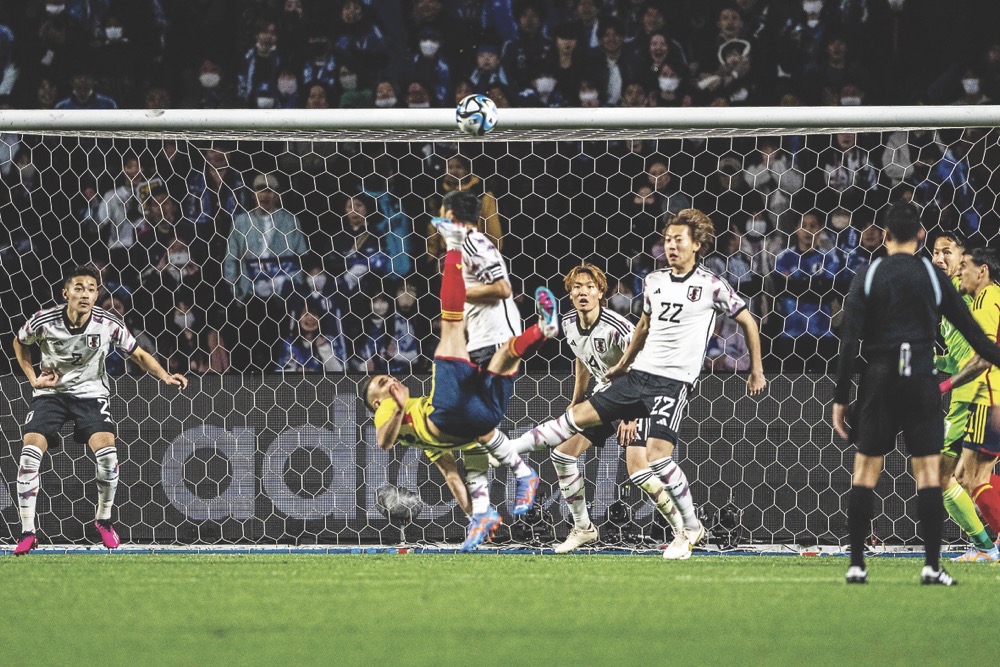 Colombia’s Rafael Santos Borre, center, scores an spectacular goal during their friendly football match against Japan in Osaka on Tuesday. Colombia won 2-1. (AFP)