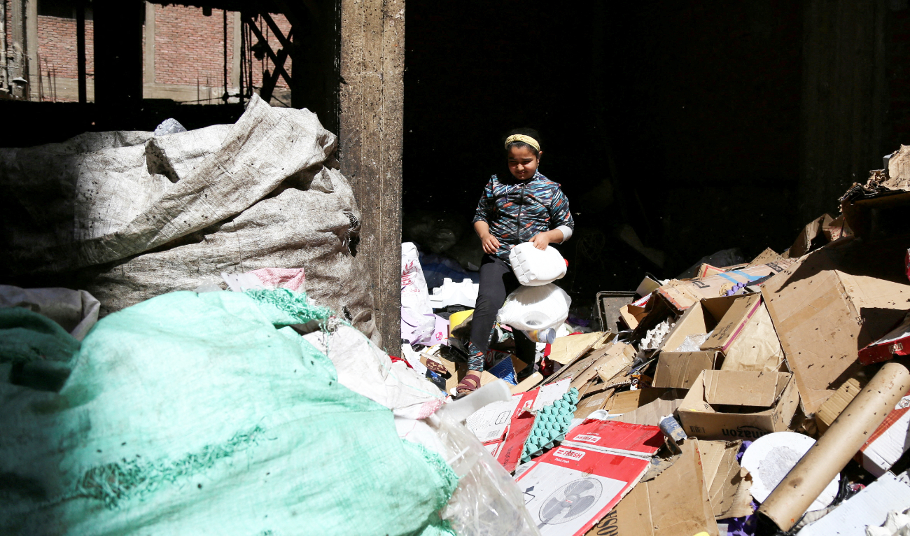 A resident child of Cairo's Zabaleen known as “Garbage City” and member of charity “Mesaha”, collects materials from rubbish to recycle in Manshiyat Nasser, Cairo, Egypt March 17, 2023. (Reuters)