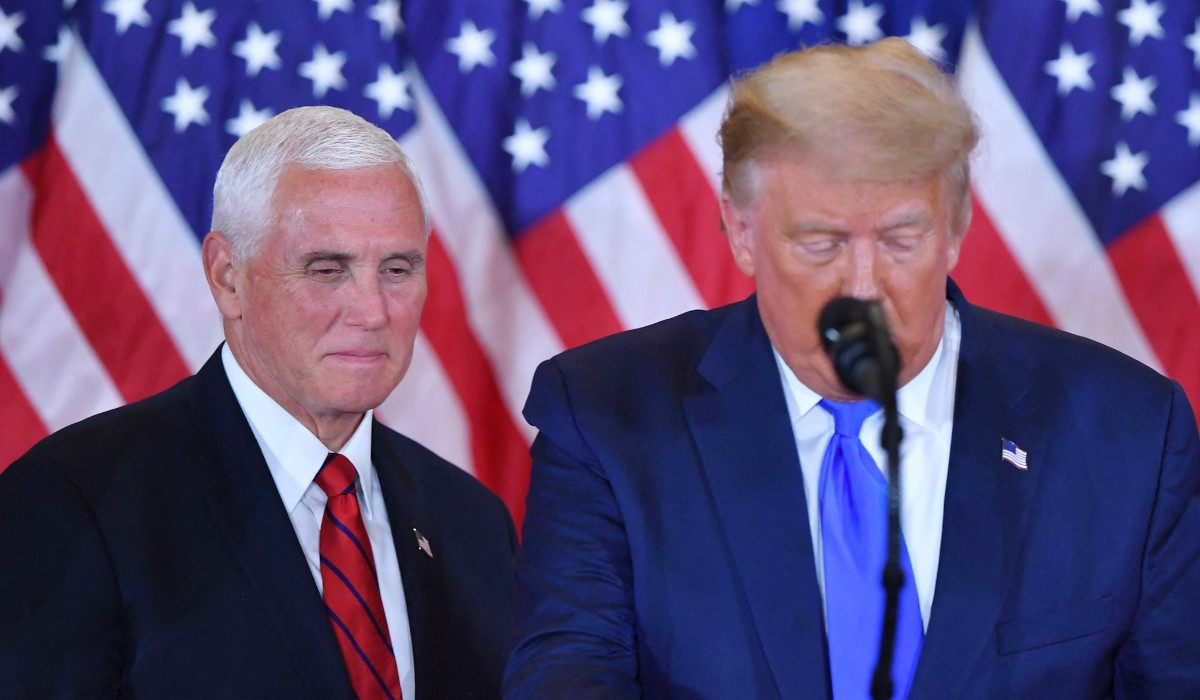 In this file photo taken on November 4, 2020 US Vice President Mike Pence (L) listens as US President Donald Trump speaks during election night in the East Room of the White House in Washington, DC. (AFP)
