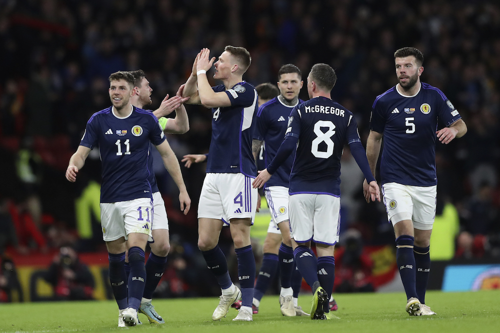 Scotland's Scott McTominay, third from left, celebrates with his teammates after scoring his side's second goal during the Euro 2024 Group A qualifying soccer match between Scotland and Spain at the Hampden Park stadium in Glasgow Tuesday (AP)